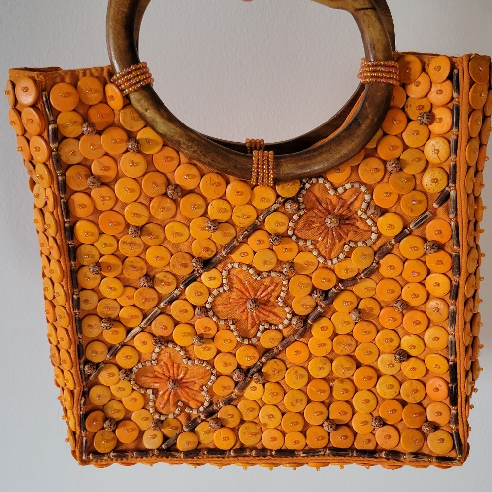 Unique orange beaded detail purse with wood handle.